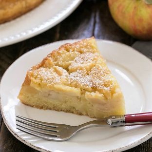 Slice of French Apple Cake on a round dessert plate