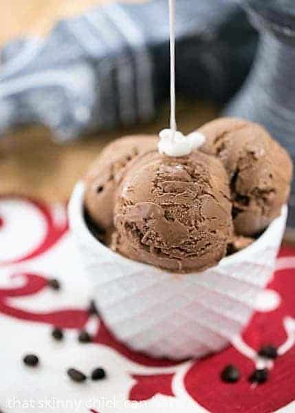 Mocha Ice Cream in white bowl with Marshmallow Cream Sauce pouring on top.