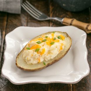 Twice baked potato on a square white plate