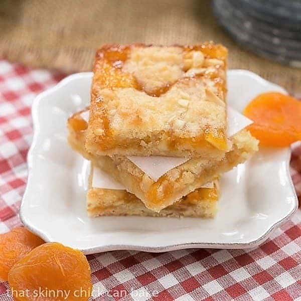 Coconut Apricot Bars stacked on a small white plate.