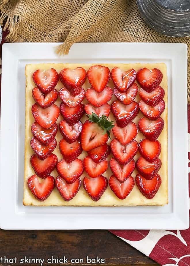 Strawberry Cheesecake Bars on a square white platter.