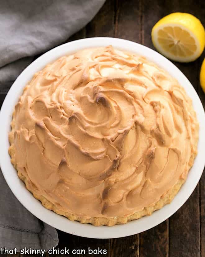 Overhead view of lemon meringue pie in a white ceramic pie plate