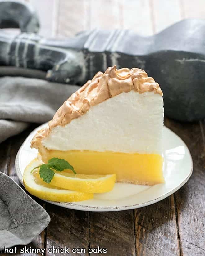 Slice of Mile High Lemon Meringue Pie on a white plate
