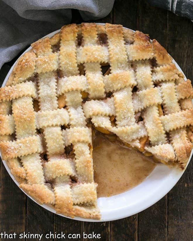 Peach Pie with a lattice crust with a slice removed