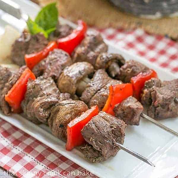 Tender Skewered Grilled Beef Steak Kabobs on a white tray