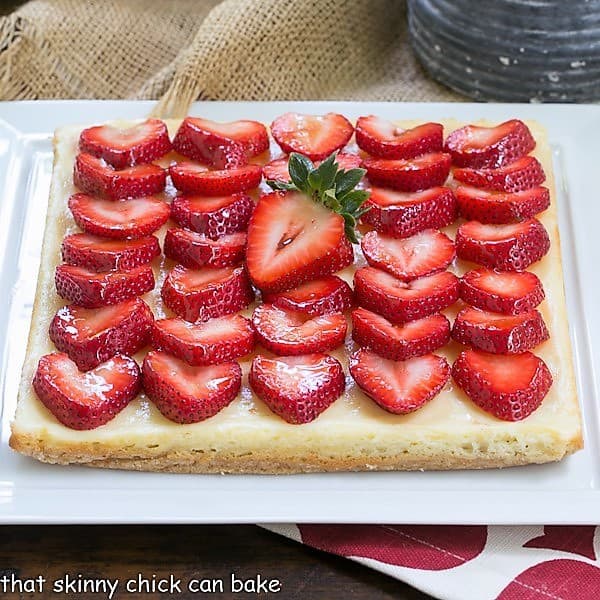 Strawberry Cheesecake Bars topped with sliced berries 