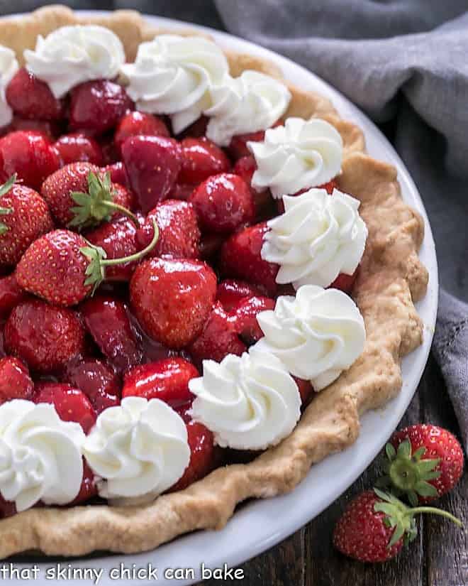 Overhead view of half a Fresh Strawberry Pie in a white pie plate
