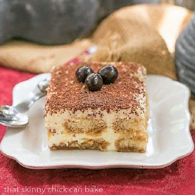 Slice of Classic Tiramisu on a square white plate.