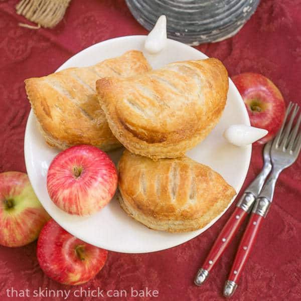 Chaussons aux Pommes overhead view on a white serving dish on a red napkin.