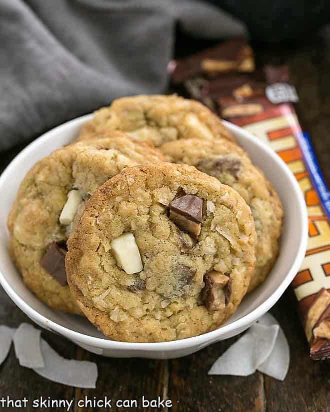 Chewy Oatmeal Toffee Cookies with a coconut bonus - fabulous flavors and textures in every bite make for truly irresistible cookies! Chewy Oatmeal Toffee Cookies in a white bowl.