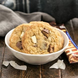 Chewy Oatmeal Toffee Cookies in a white bowl with coconut flakes and Heath bars