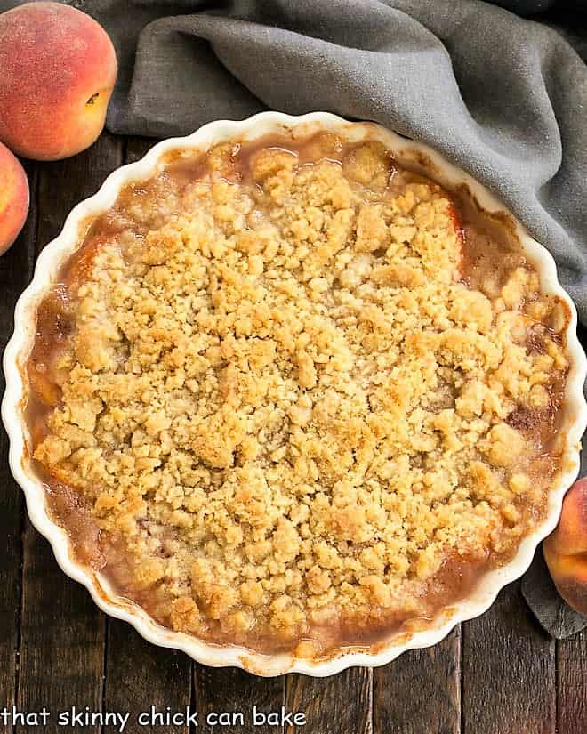 Overhead view of a Classic Peach Crisp in a white ceramic dish