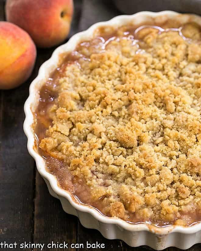 Classic Peach Crisp in a round scalloped casserole dish