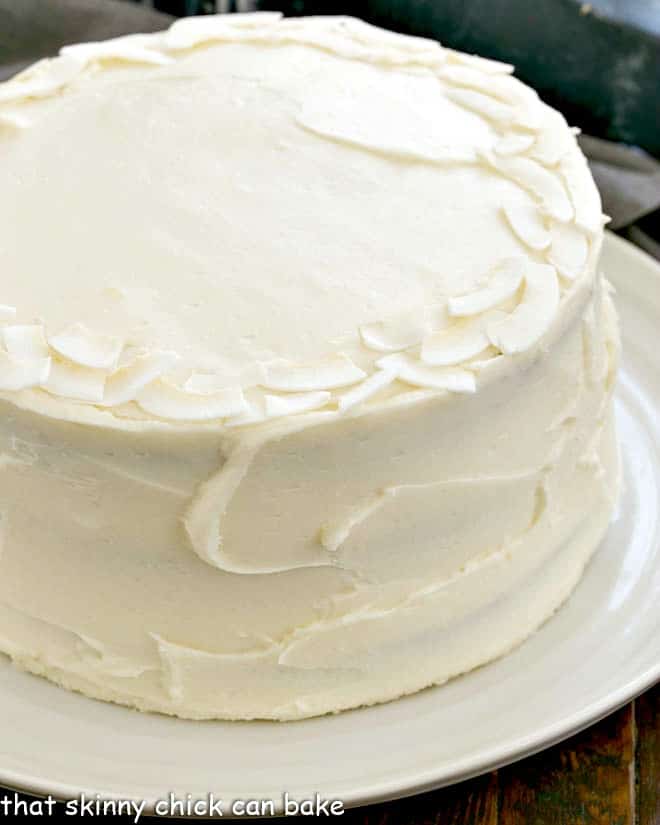 Siide view of anItalian Cream Cake on a white serving plate.