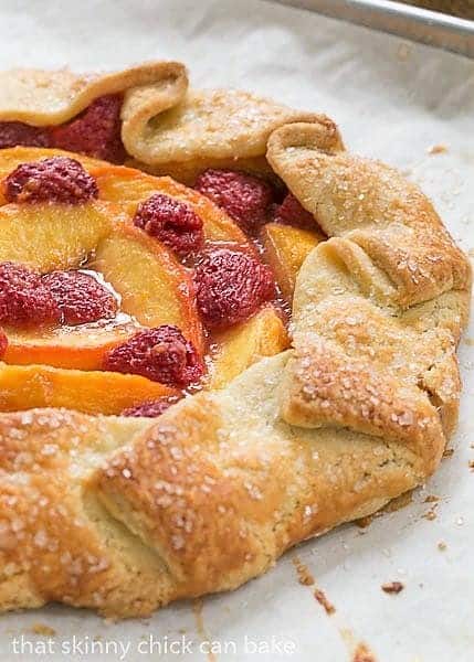 Peach Raspberry Galette on a parchment lined baking sheet.