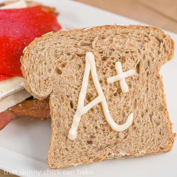 Roasted Chicken Brie and Bacon Sandwich with top slice of bread in front.