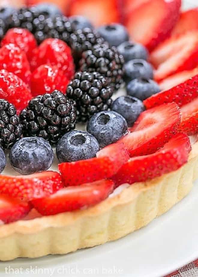 Summer Fruit Tart - Pastry crust with whipped cream and cream cheese filling topped with glorious summer berries Close up shot of the fruit on this Summer Fruit Tart.