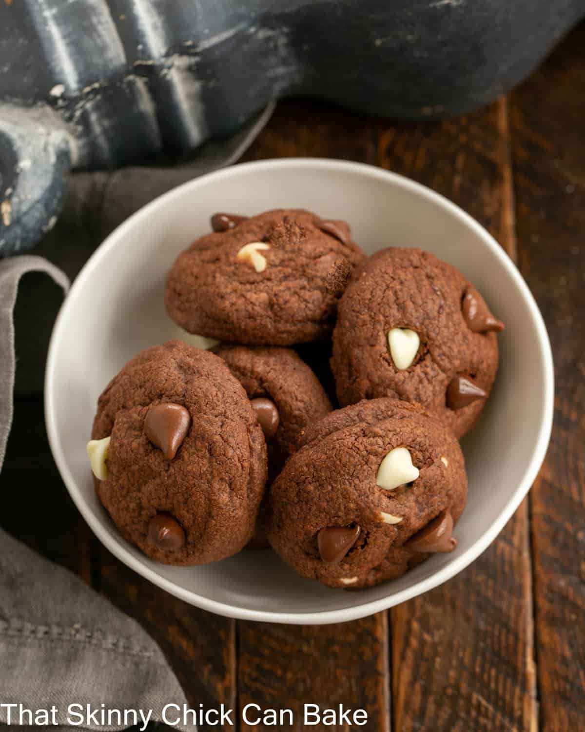 White bowl filled with 5 triple chocolate chip cookies.