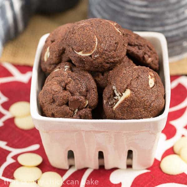 Triple chocolate chip cookies in a white ceramic basket.