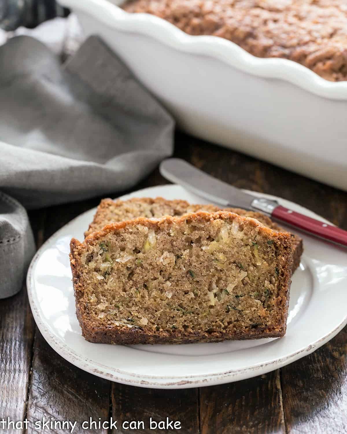 Slices of pineapple zucchini bread on a white ceramic platter.