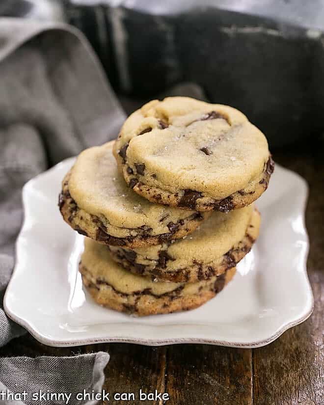 Layered Chocolate Chip Cookies stacked on a square white plate.