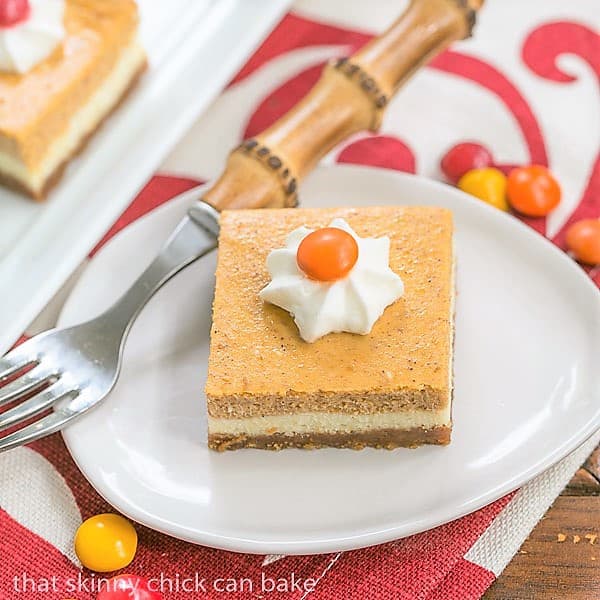 Pumpkin Cheesecake Bars - Biscoff crust topped with a layer of plain then pumpkin cheesecake!