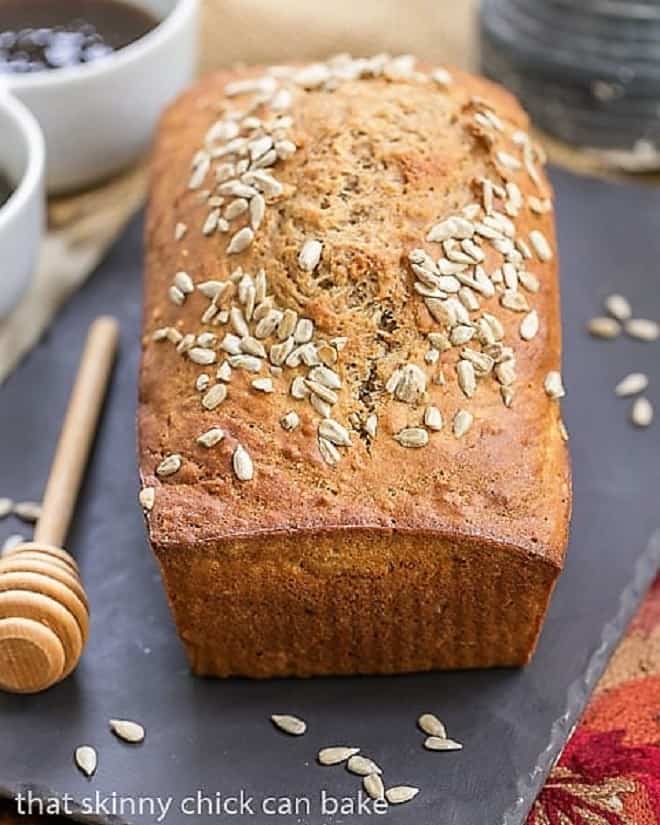 Loaf of Sunflower Whole Wheat Bread on a slate tray.