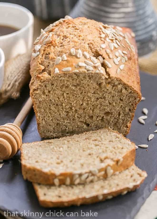 Loaf and Sliced Sunflower Whole Wheat Bread on a slate tray 