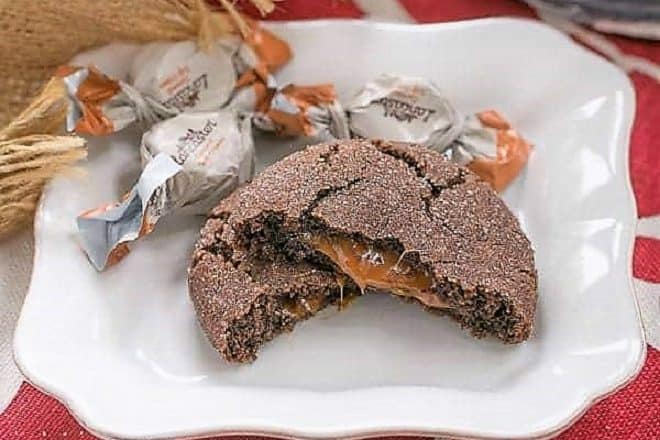 Caramel Filled Chocolate Cookies with oozing caramel revealed on a square white plate