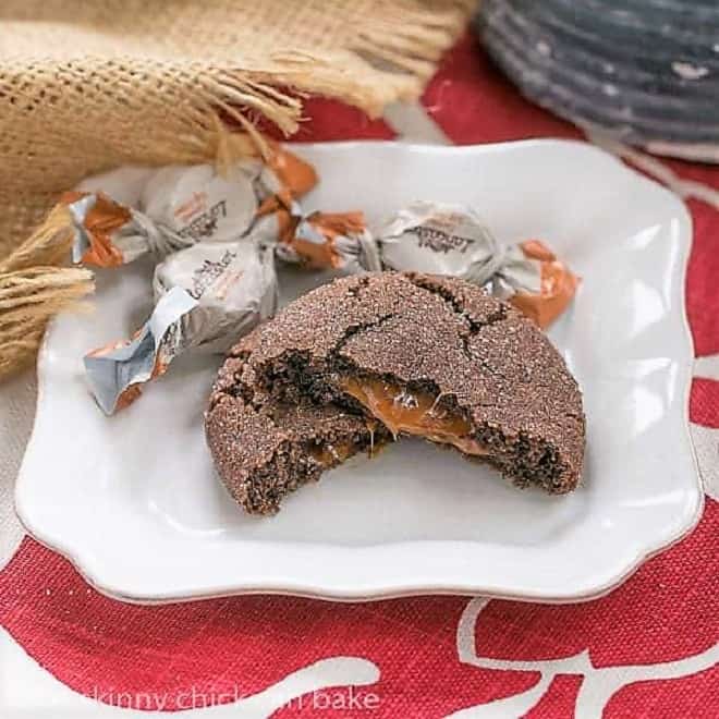 Caramel Filled Chocolate Cookies with oozing caramel revealed on a square white plate.