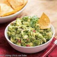 Mary's Classic Guacamole in a white ceramic bowl with a red handled serving spoon