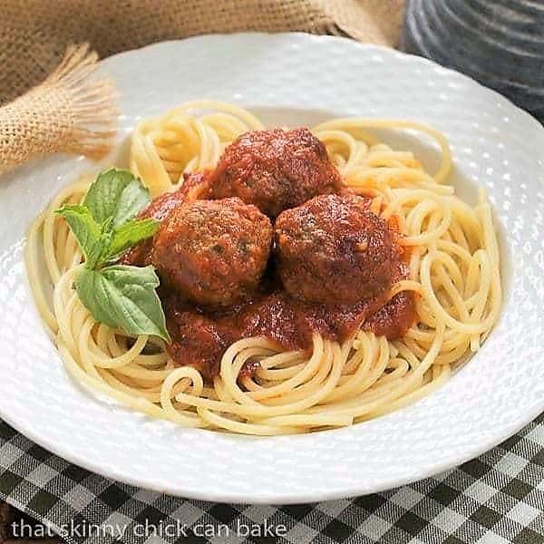 Classic Italian Meat Sauce in white bowl garnished with basil.