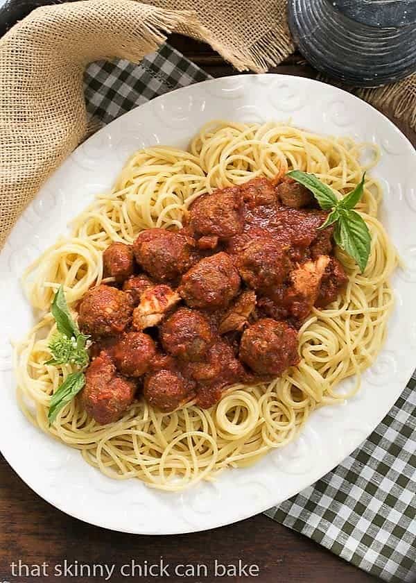 Spaghetti Sauce Recipe - Slowly simmered tomato and meat sauce made the Italian way! Classic Italian Meat Sauce over pasta on a white platter.