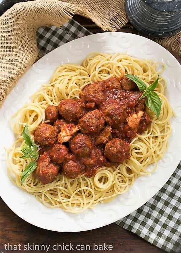 Classic Italian Meat Sauce over pasta on a white platter.