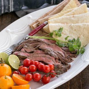 Beef Steak Fajitas sliced and on a tray with all the fixings!
