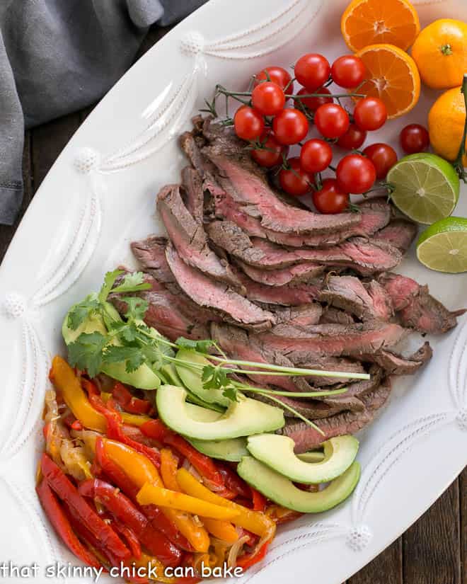 Easy Steak Fajitas Recipe and toppings from above on a white tray