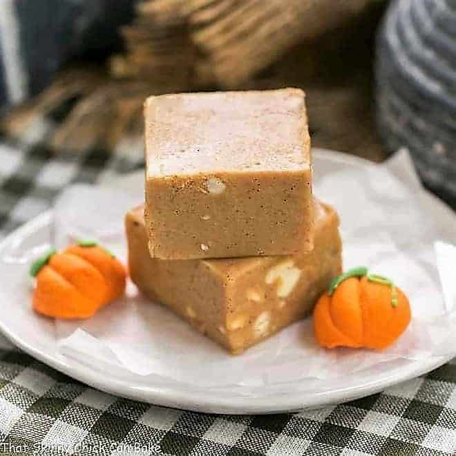 Easy Pumpkin Fudge stacked on a round white plate.
