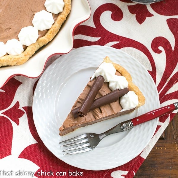 A slice of Classic French Silk Pie on a plate with a red handled fork.