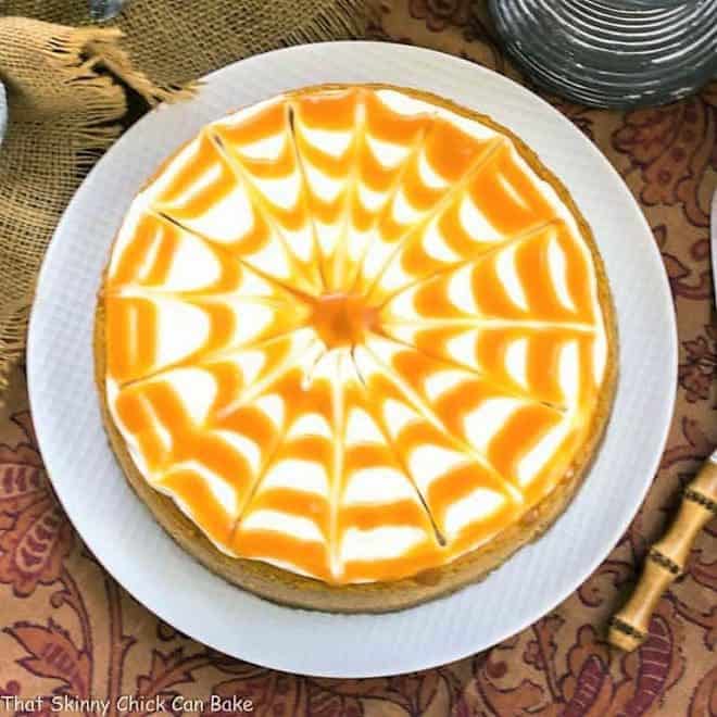 Caramel Topped Pumpkin Cheesecake from above on a white cake plate