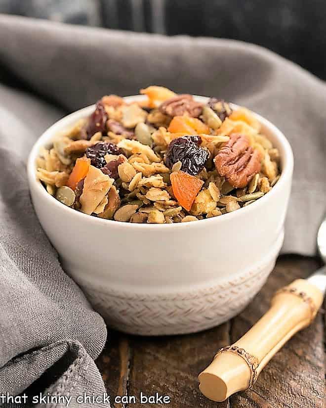 Maple Coconut Granola in a white cereal bowl with a spoon