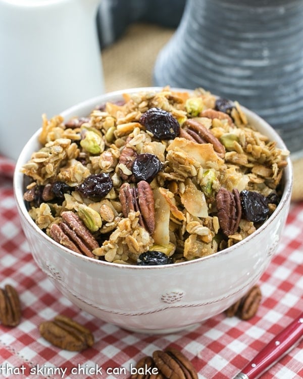 Maple Coconut Granola  in a large white bowl on a checked napkin.