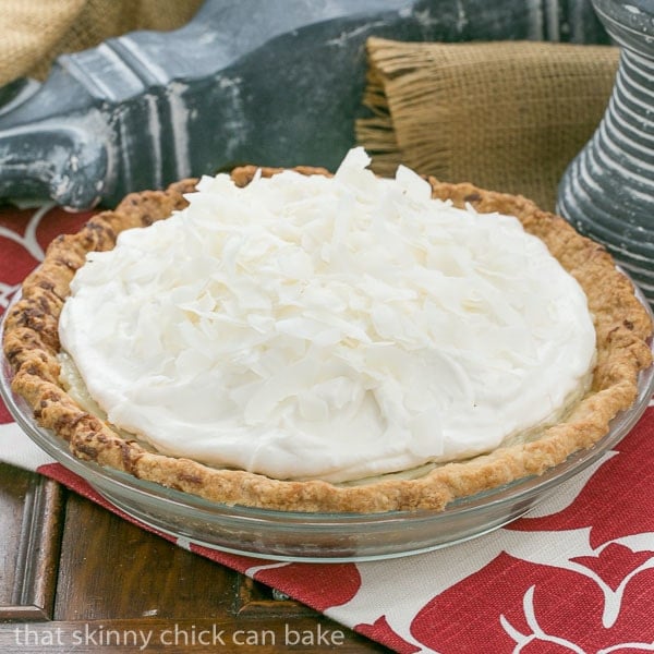 Coconut Cream Pie | Coconut crust filled with creamy coconut laden custard with a decadent whipped cream topping!