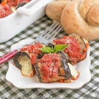 Eggplant Rollatini on a white dish with a red handled fork