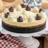 Layered Chocolate Cheesecake on a white cake stand