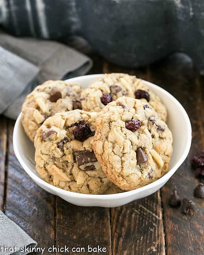 Shallow white bowl with 4 chewy oatmeal cookies.