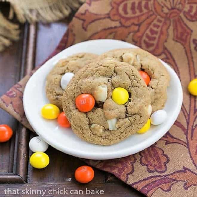 3 M&M White Chocolate Macadamia Nut Cookies on a small white plate.