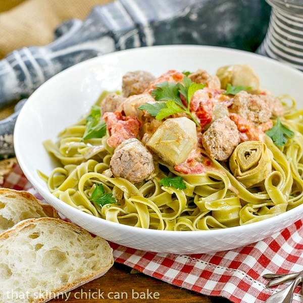 Pasta with Sausage and Cream in a white ceramic serving bowl for an Italian Holiday Feast