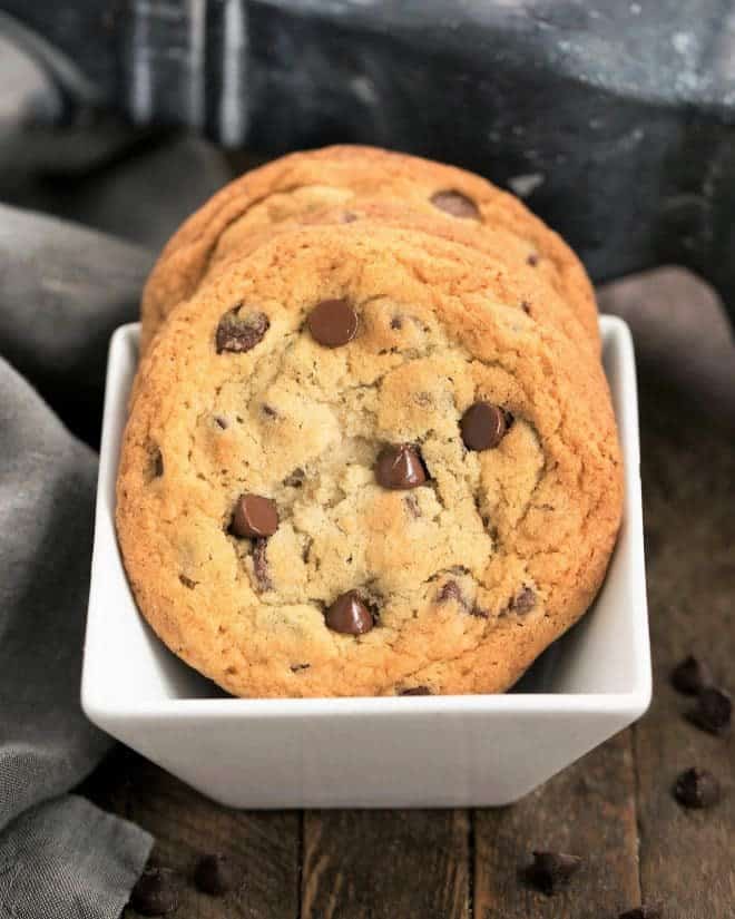 Thin Chewy Chocolate Chip Cookies in a square white bowl