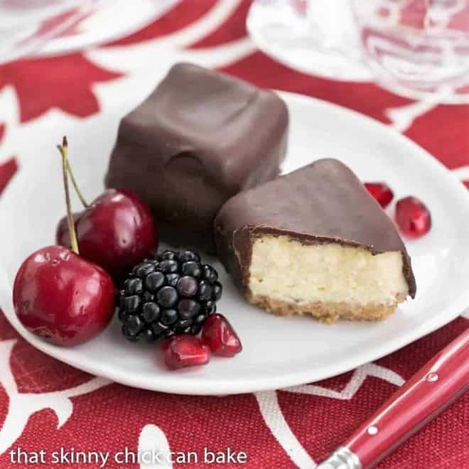 Chocolate Dipped Cheesecake Bites on a small white dessert plate