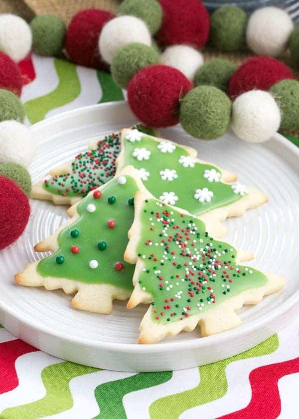 Best Sugar Cookies on a white plate on a Christmas napkin with holiday felt garland